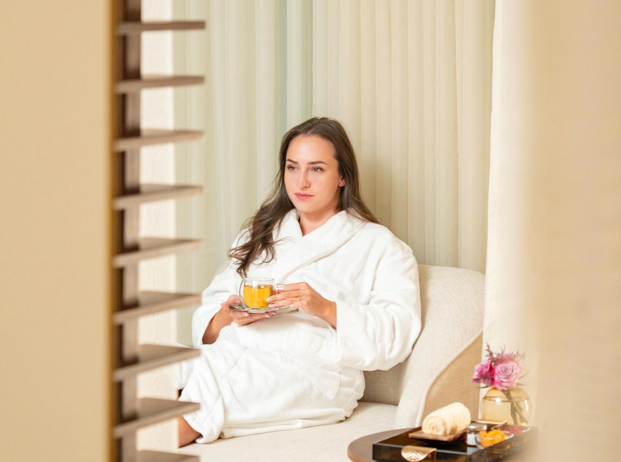 Fairmont Эр-Рияд Экстерьер фото A woman wearing a bathrobe